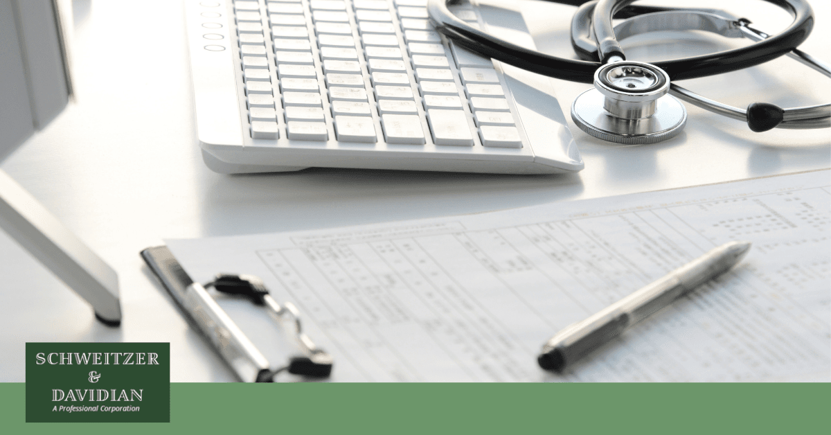 stethoscope, clipboard, pen, and a computer keyboard