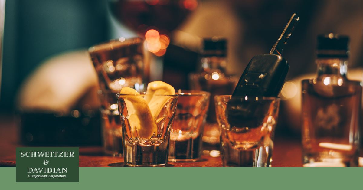 empty shot glasses at a bar with car key inside one