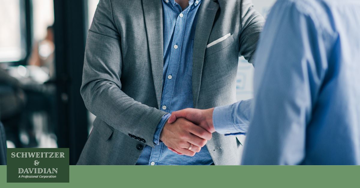 two men in professional clothes shaking hands