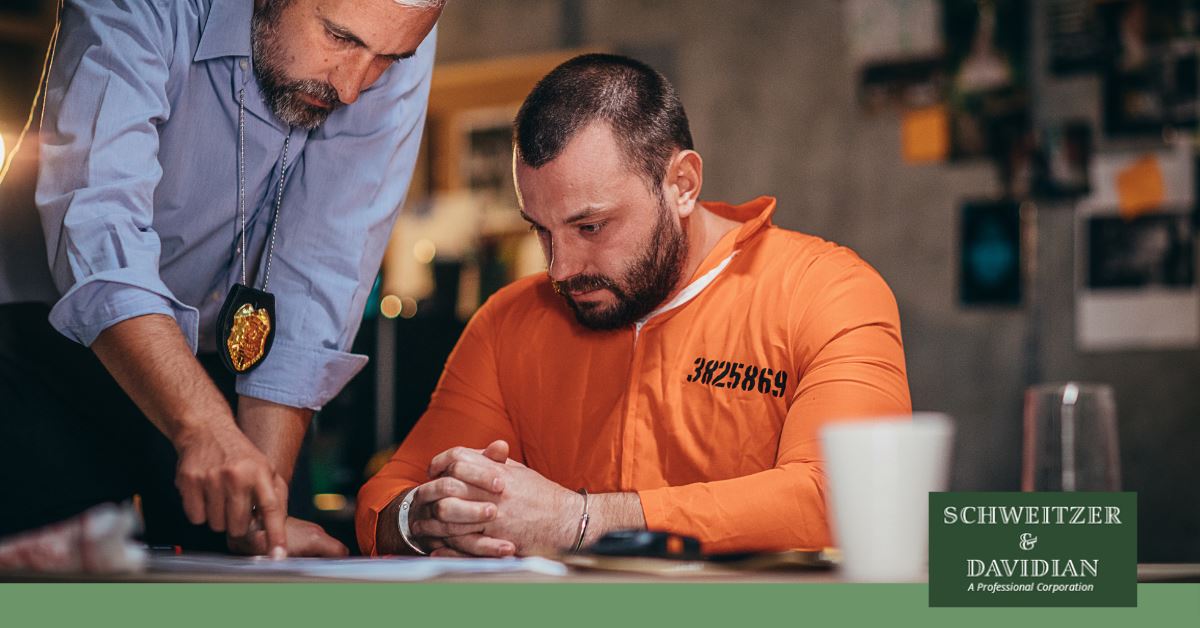 inmate and police officer looking at a paper on a table