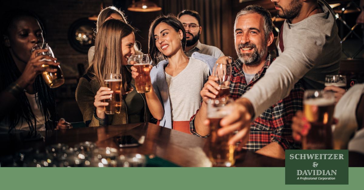 big group of people drinking beer at a bar